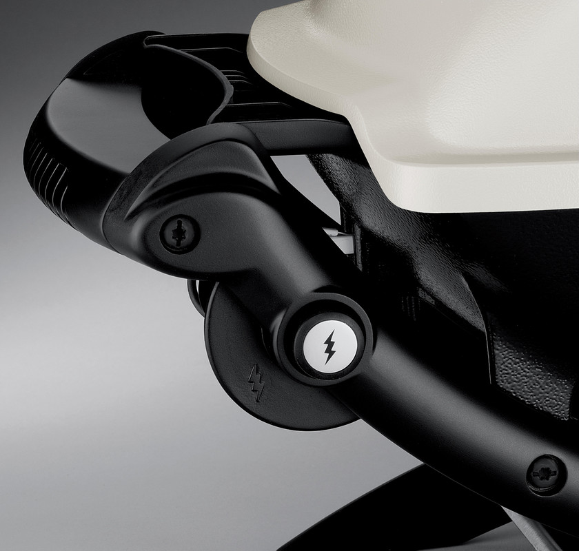 Close-up view of a black electric scooter's handlebar, focusing on the throttle and power button marked with an insert symbol.