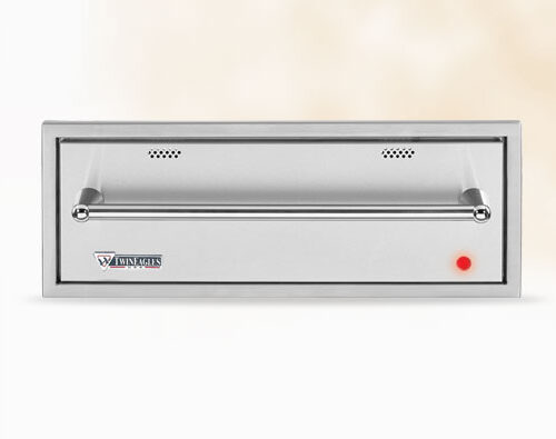 A modern, stainless steel return air grille with a small red indicator light mounted on a wall, featuring the "wingates" logo on the bottom right insert.