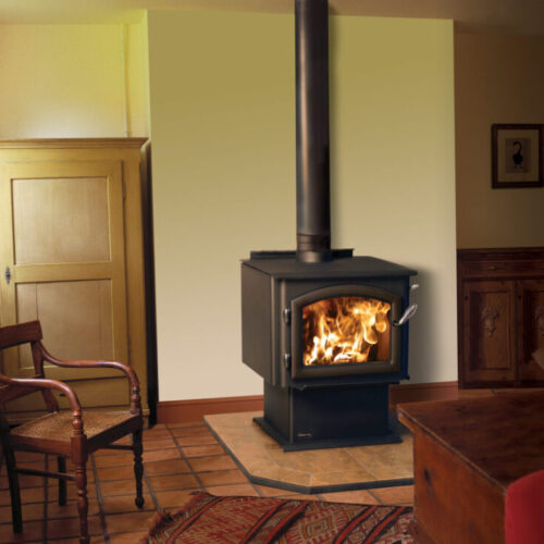 3100 Millennium standard wood stove by Quadra-Fire against a tan wall of a living room with hearth pad