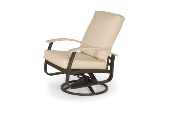 A beige cushioned rocking chair with a dark brown frame, set against a plain white background near a fireplace.