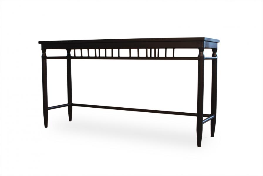 A modern black console table with a sleek design and a rectangular top, featuring symmetrical, column-like legs and a horizontal stretcher with geometric details, isolated on a white background by a fireplace.