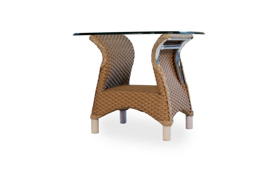 A modern magazine rack and table combo made of woven rattan with a clear glass top, isolated on a white background, designed to complement a cozy fireplace setting.
