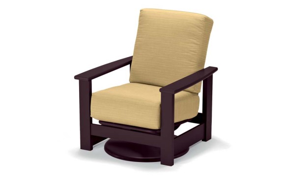 A modern rocking chair with a dark brown frame and light beige cushions, inserted by a fireplace on a white background.