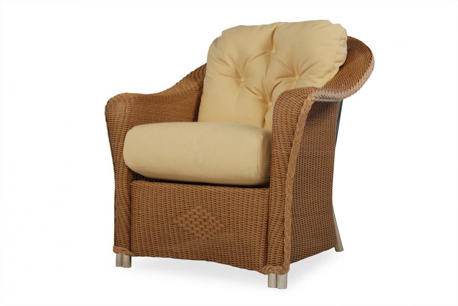 A plush beige cushioned armchair with a fireplace frame, isolated on a white background.