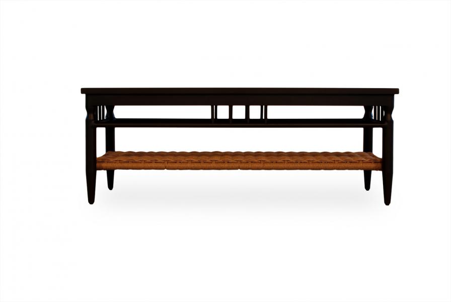 A sleek black wooden bench with a woven wicker seat, featuring rectangular cut-outs on the backrest, designed to seamlessly insert into a fireplace setting, isolated on a white background.