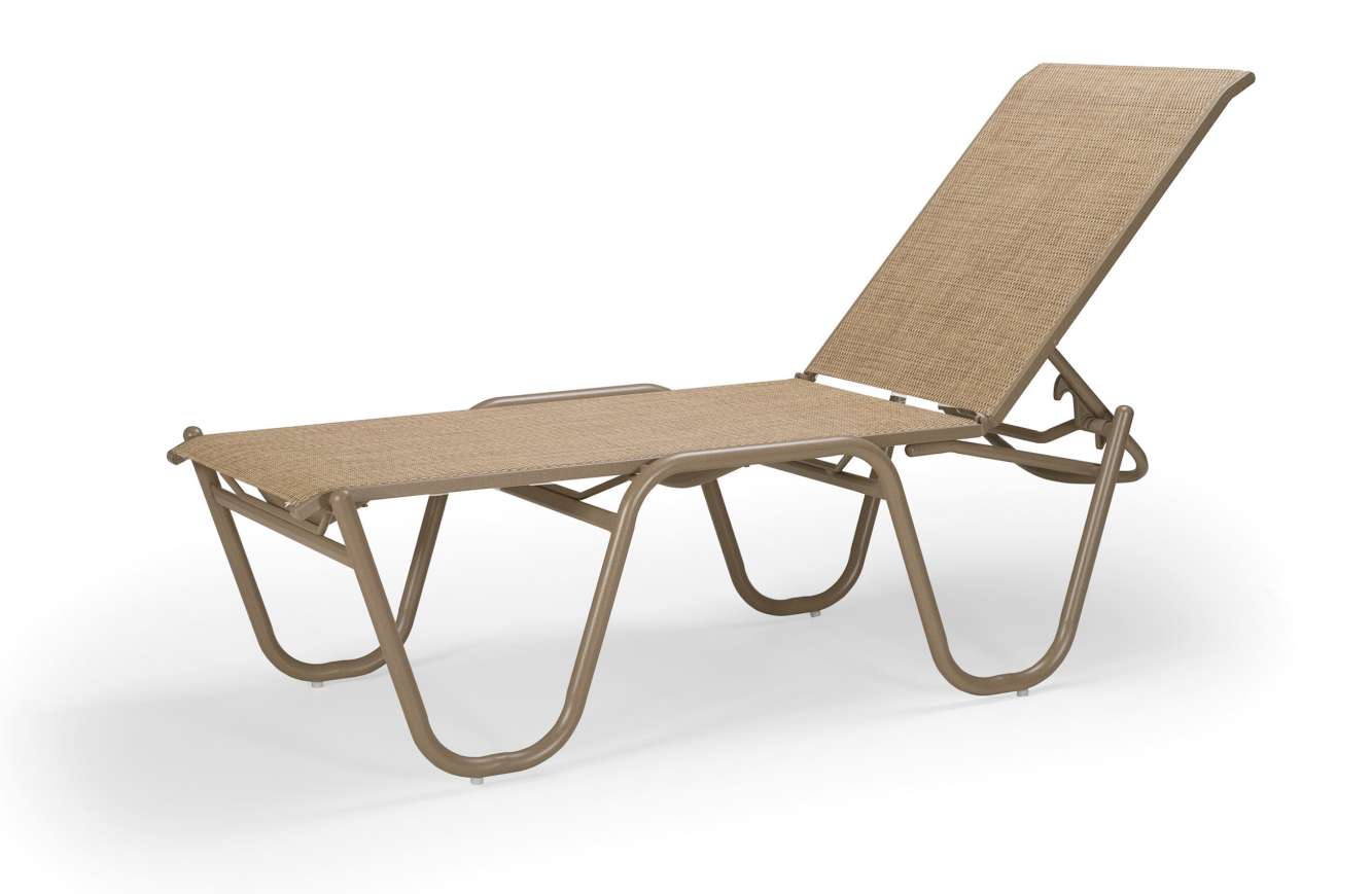Beige outdoor reclining lounge chair near a fire pit, on a white background, featuring a durable frame and fabric for comfort and style.