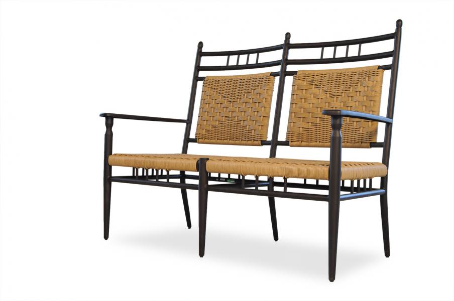 A modern double seat with a black metal frame and tan woven backrests and seat cushions, isolated on a white background, ideal for placement around a fire pit.