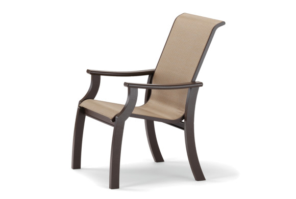 A modern, dark wooden armchair with a slanted back and a beige upholstered seat, placed near a fireplace, isolated on a white background.