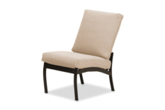 A modern beige upholstered chair with a slanted back and dark wooden legs beside an elegant fire pit on a white background.