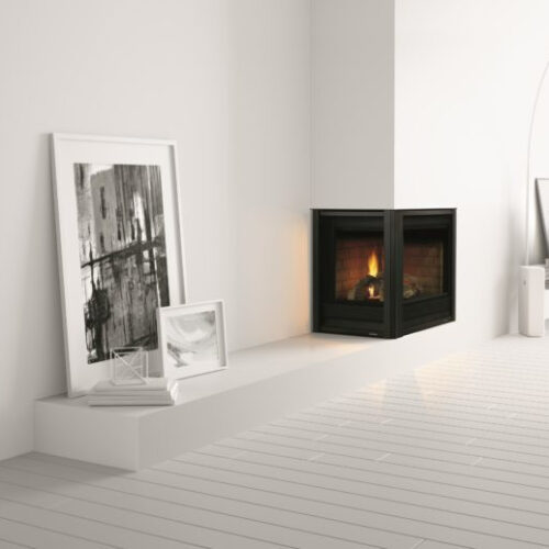 Corner Series modern gas fireplace by Heat & Glo in black against a white corner wall in a living room