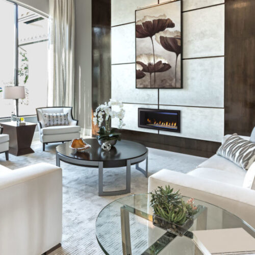 Cosmo Series gas fireplace by Heat & Glo in black with Clean Face front against a white marble pattern hearth