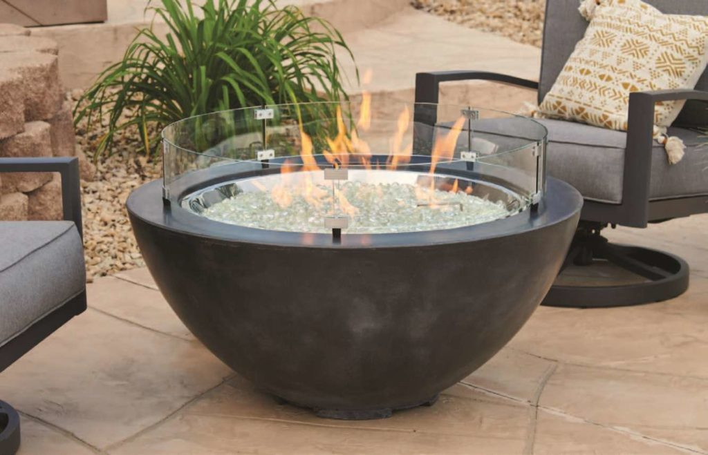 Cove Collection round gas fire pit with Black Supercast concrete in an outdoor living space near patio furniture