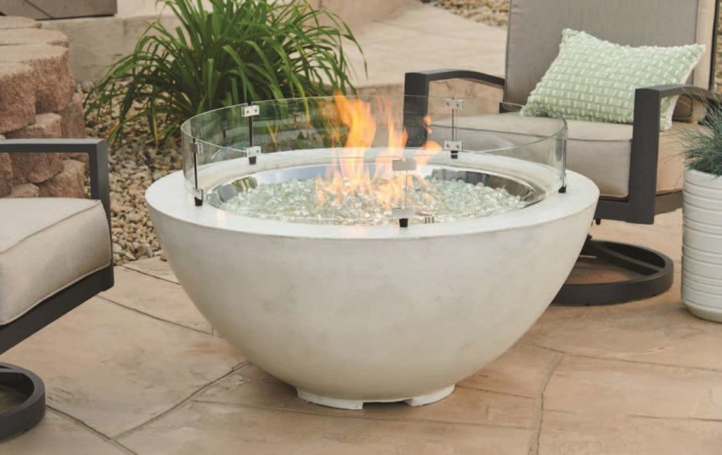 Cove Collection round gas fire pit with White Supercast concrete in an outdoor living space near patio furniture