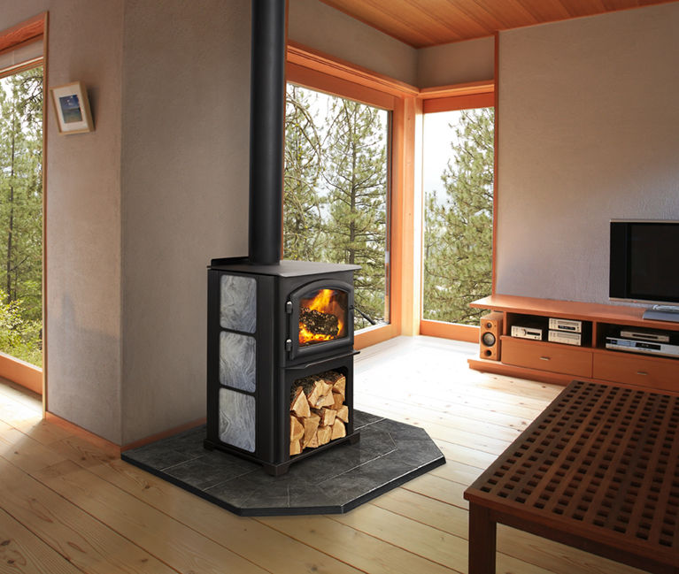 Discovery II wood stove by Quadra-Fire with custom personalized side panel against a tan wall of living room