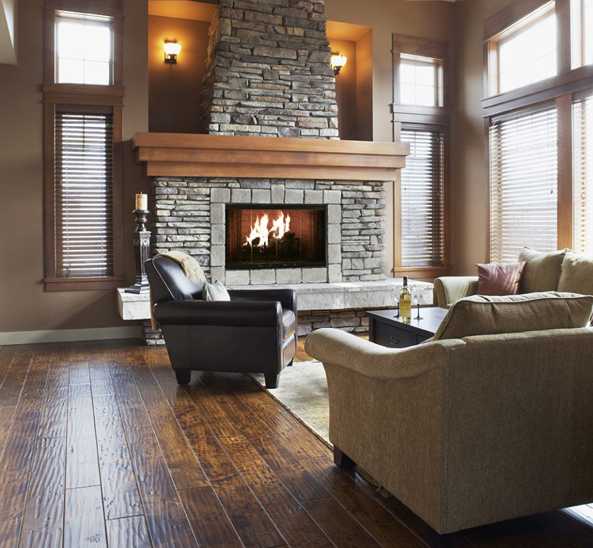 Element wood fireplace by Heatilator with black trim and dark gray stone surround and hearth in rustic living space