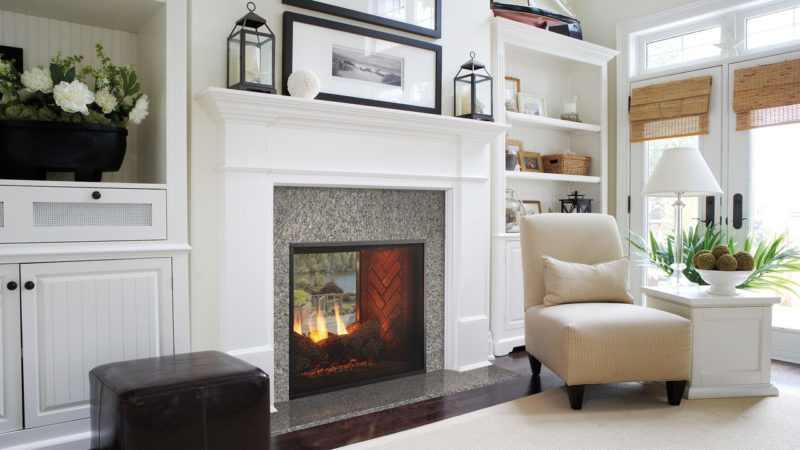 Fortress see-through indoor/outdoor gas fireplace by Outdoor Lifestyles against marble style hearth