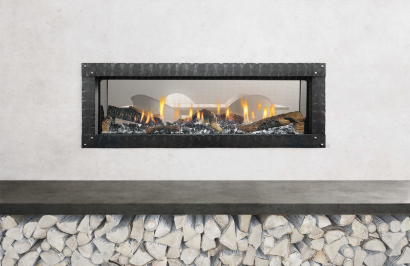 Mezzo 48-inch see-through gas fireplace by Heat & Glo with Loft Forge front against a modern white hearth