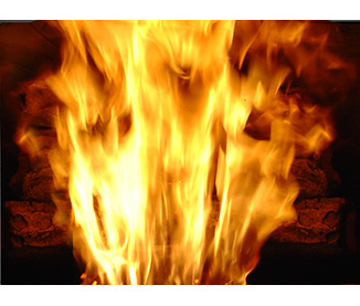 closeup of a fire using a log set in the P68 pellet stove by Harman, showing the flame and heat dispersing