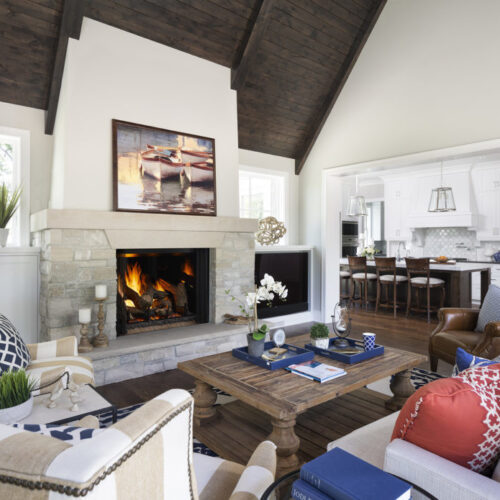 Phoenix TrueView gas fireplace by Heat & Glo in black against a light gray stone masonry hearth in a living room