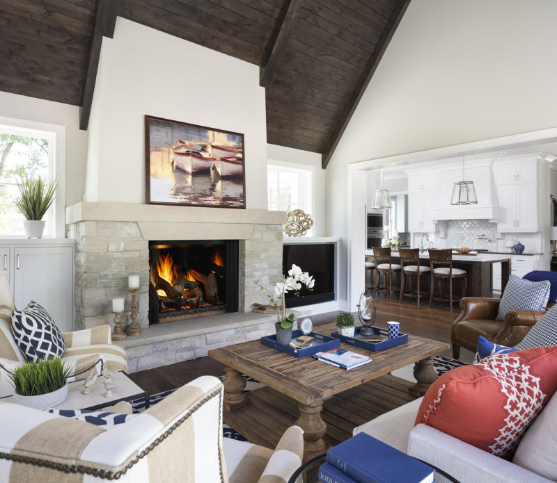 Phoenix TrueView gas fireplace by Heat & Glo in black against a light gray stone masonry hearth in a living room