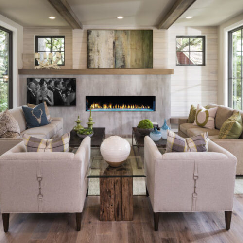 Primo single-sided gas fireplace by Heat & Glo with Aqua Light LED lighting against a modern gray concrete style hearth