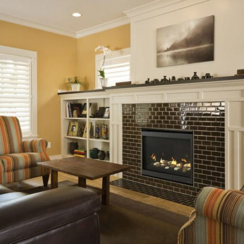 SlimLine Fusion series gas fireplace by Heat & Glo in black with Clean Face front against a ceramic brick pattern hearth