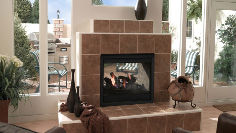 Twilight see-indoor/outdoor gas fireplace by Outdoor Lifestyles with Firescreen front against tan tile hearth