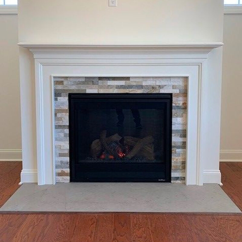 a fireplace with a fire in it in a living room.