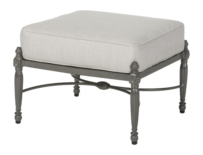 An elegant Gensun Bel Air ottoman with a light gray cushion and a dark gray metal frame featuring ornate, classical-style legs.