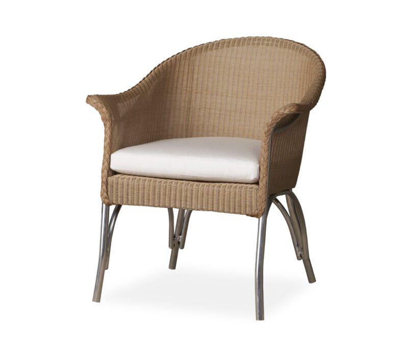 A wicker tub chair with a white cushion on a metal base, isolated on a white background.
