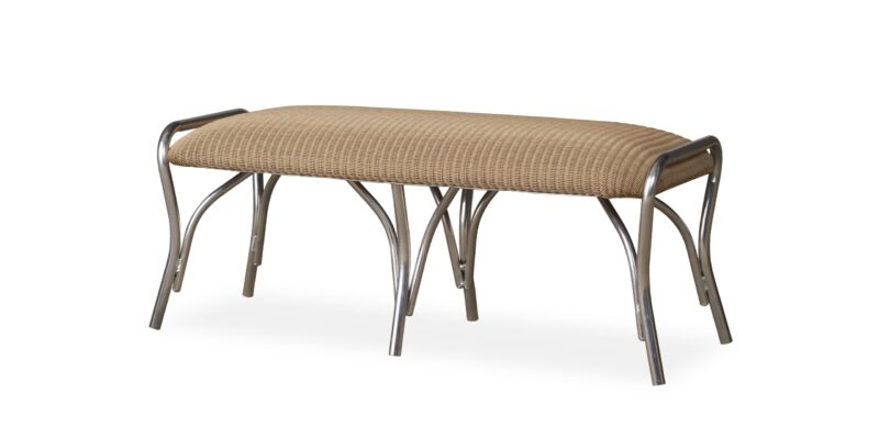 A woven rattan bench with a curved, elongated seat and metallic, arched legs isolated on a white background.
