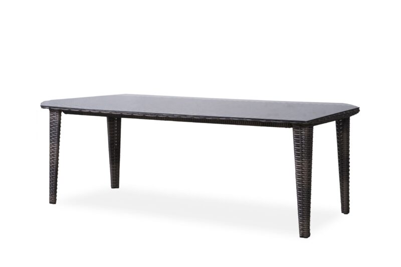 A rectangular dark woven wicker table with a solid top, standing isolated against a plain white background.