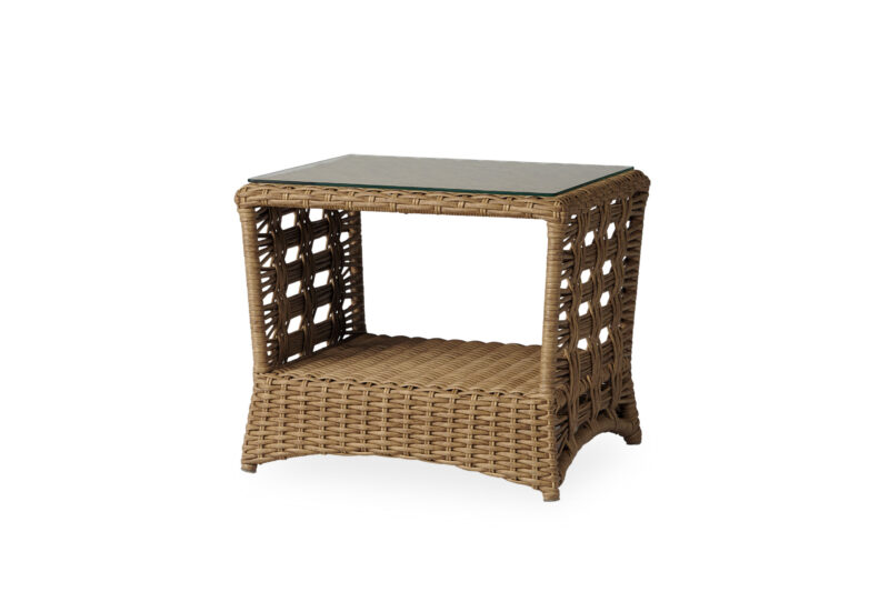 A wicker bedside table with an open shelf and a stone top, isolated on a white background.