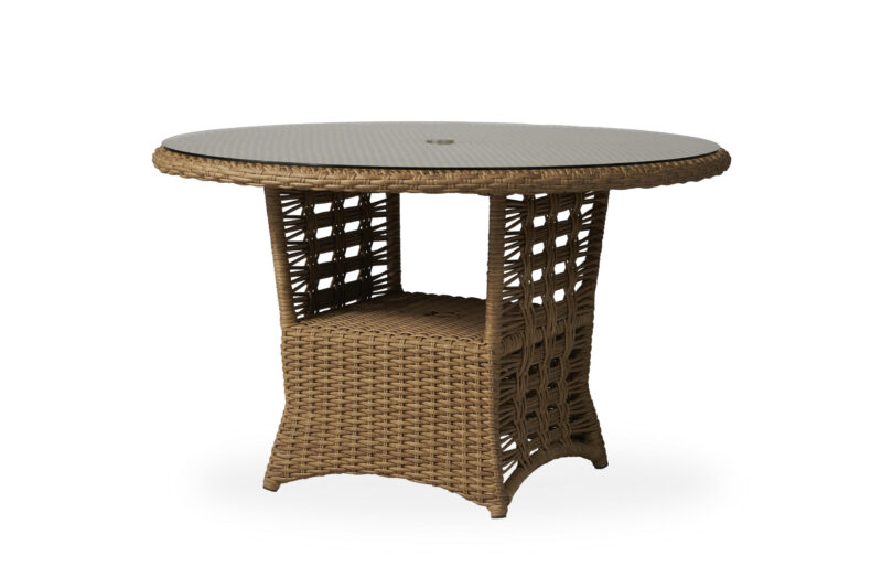 A round wicker table with an intricate lattice design on the base, featuring a smooth top with a central hole, isolated on a white background.