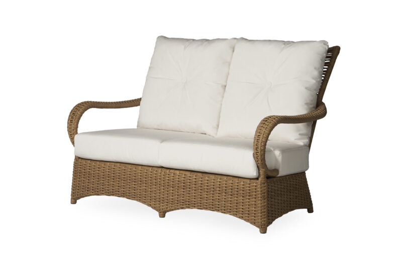 A wicker two-seater outdoor sofa with white cushions, photographed against a white background.
