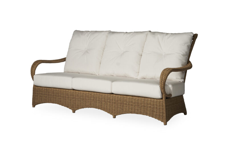 A wicker outdoor sofa with a cushioned back and seat in light beige, set against a white background. .