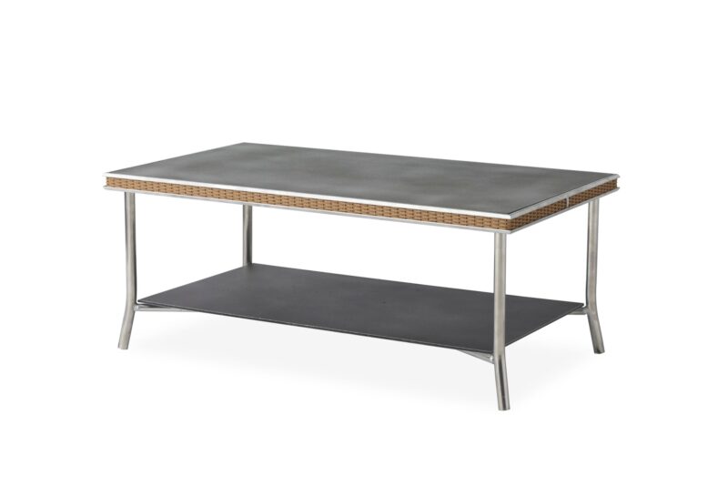 A modern coffee table with a grey tabletop and lower shelf, featuring a thin rattan edge and sleek metal legs, isolated against a white background.