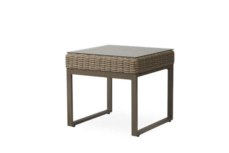 A modern outdoor side table with a metal frame and a wicker basket design under a ceramic tile top, isolated on a white background.
