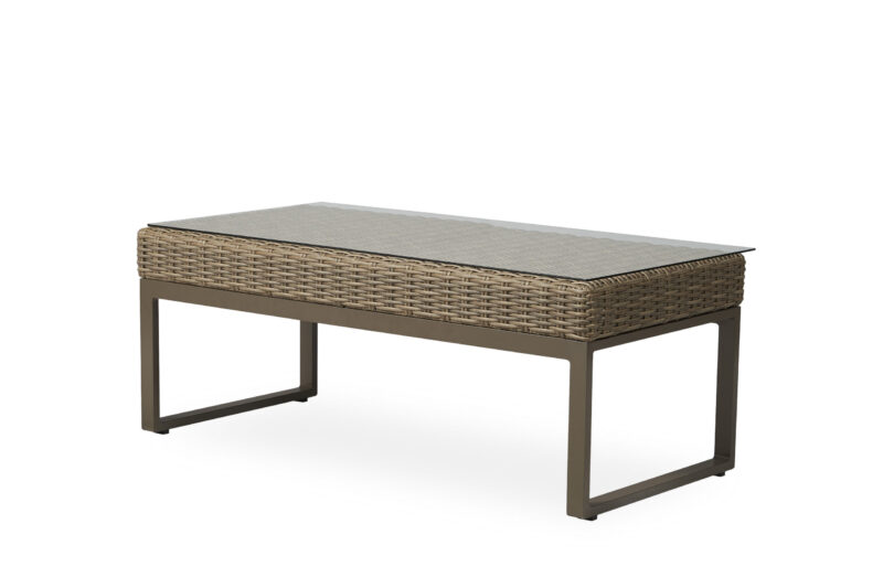 A modern outdoor coffee table featuring a metal frame and a woven rattan top, complemented by a flat grey surface. the table is set against a plain white background.