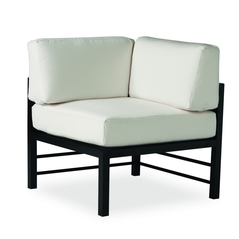 A modern corner chair with a black metal frame and white cushions, isolated on a white background.