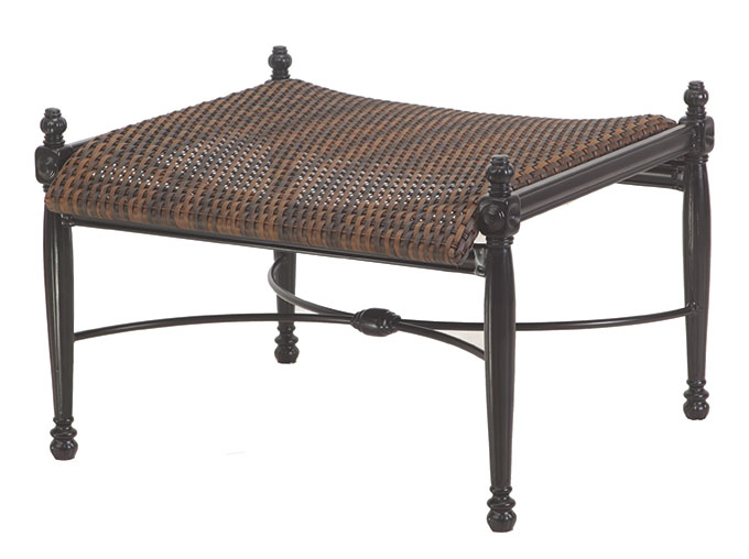 A square ottoman with a dark, woven wicker top and a Gensun Bel Air metal frame featuring ornamental details, isolated on a white background.