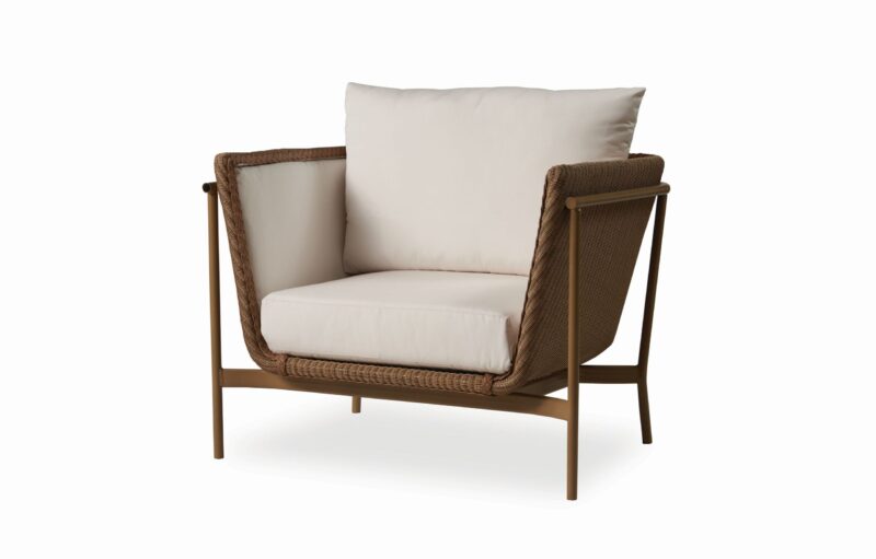 A modern armchair with a wooden frame and woven sides, featuring plush, white cushions on a seamless white background.
