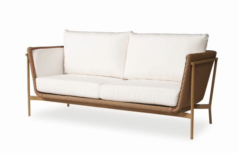 A modern sofa with a wooden frame and white cushions, featuring woven side panels, isolated on a white background.