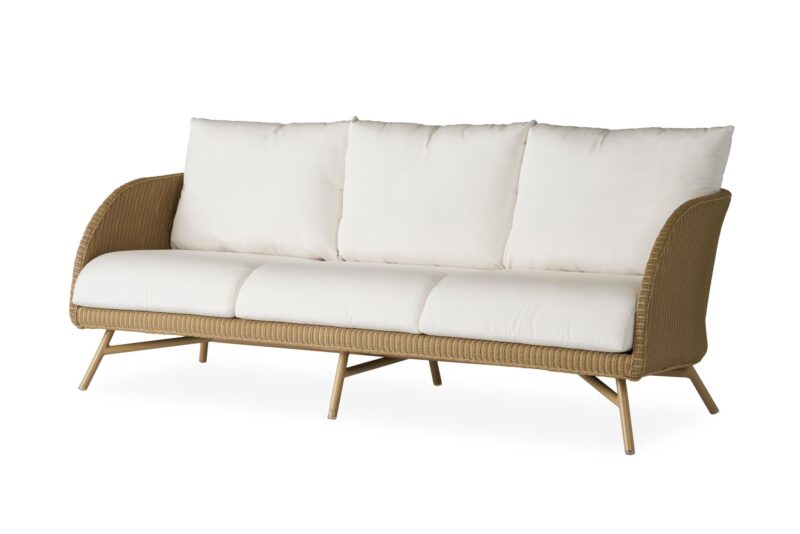 A modern wicker three-seater sofa with light beige cushions on a white background.