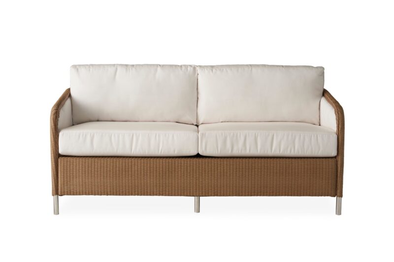 Modern tan wicker loveseat with white cushions, featuring a simple and sleek frame, isolated on a white background.
