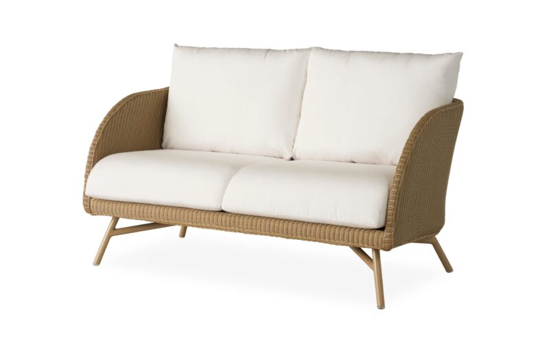 A modern two-seater sofa with a woven beige frame, angled wooden legs, and plush white cushions, isolated on a white background.