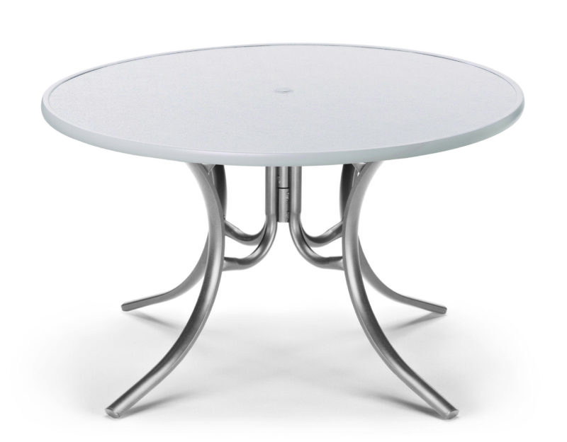 A modern round table with a sleek, gray surface and a unique, metallic base consisting of intertwining curved legs, isolated on a white background.