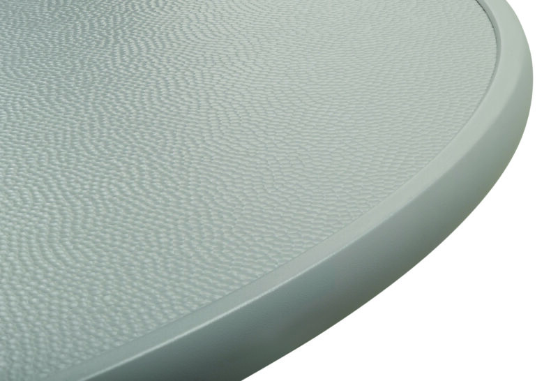 Close-up of a textured white surface with a rounded grey edge, possibly part of a plastic or metal item.