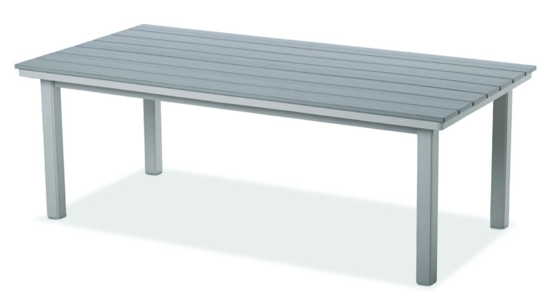 A simple, modern outdoor table with a rustic grey polymer top and white metal legs, isolated on a white background.
