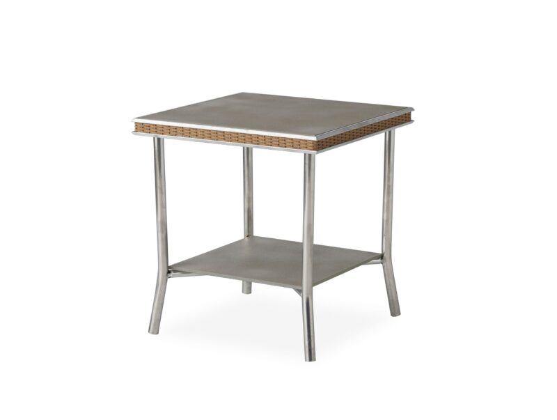A modern side table with a square top and a lower shelf, featuring sleek metal legs and a woven rattan edge detail. the tabletop and shelf have a smooth, gray finish.